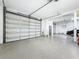 Spacious three-car garage with epoxy flooring, offering ample parking and storage space at 3924 N Ridge Ave, Tampa, FL 33603