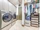 A laundry room complete with a washer, dryer, and a walk in closet with shelving units at 3924 N Ridge Ave, Tampa, FL 33603
