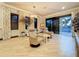 Bright sitting room with tile floors, stylish armchairs, and access to outdoor views via sliding glass door at 3924 N Ridge Ave, Tampa, FL 33603
