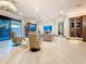 Spacious living room with tile flooring, recessed lighting, and sliding glass doors to the outdoor area at 3924 N Ridge Ave, Tampa, FL 33603