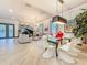 Open-concept living and dining area featuring a piano, modern decor, and tile flooring at 3924 N Ridge Ave, Tampa, FL 33603