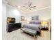 Comfortable main bedroom features an upholstered headboard, ceiling fan, and two bedside tables with lamps at 3924 N Ridge Ave, Tampa, FL 33603