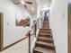 Beautiful wooden staircase with modern metal railings, complemented by artwork and natural light at 3924 N Ridge Ave, Tampa, FL 33603