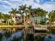 Scenic waterfront featuring manicured lawns, a gazebo, boat dock, and palm-lined properties at 3924 N Ridge Ave, Tampa, FL 33603