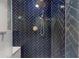 Modern bathroom shower featuring blue herringbone tile and rainfall showerhead at 4511 Huntington Ne St, St Petersburg, FL 33703