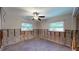 Unfinished bedroom with wood floors and two windows at 4511 Huntington Ne St, St Petersburg, FL 33703