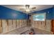 View of a blue bedroom with gray flooring, a ceiling fan, and a large window bringing in light at 4511 Huntington Ne St, St Petersburg, FL 33703