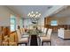 Elegant dining room with stylish chandelier, glass table set for a meal, and contemporary decor at 4511 Huntington Ne St, St Petersburg, FL 33703