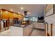 Modern kitchen featuring island, white cabinets, stone countertops, and stainless-steel appliances; partially renovated at 4511 Huntington Ne St, St Petersburg, FL 33703