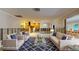 Spacious, partially renovated living room, virtually staged with stylish furniture and a large area rug at 4511 Huntington Ne St, St Petersburg, FL 33703
