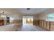A living room in progress with exposed studs and original flooring at 4511 Huntington Ne St, St Petersburg, FL 33703