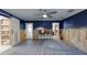 Cozy living area featuring dark blue walls, tile floors, and a sliding barn door at 4511 Huntington Ne St, St Petersburg, FL 33703