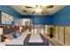Virtually staged bedroom with blue walls, gray bed and stylish decor at 4511 Huntington Ne St, St Petersburg, FL 33703