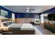 Comfortable bedroom featuring dark blue walls, wood floors, and neutral furniture at 4511 Huntington Ne St, St Petersburg, FL 33703