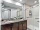 Bathroom showcasing a double vanity with granite countertop and a glass-enclosed shower at 4624 Willet Cooper Ct, Tampa, FL 33619