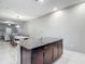 Open-concept kitchen island with granite countertops overlooking the dining and living areas at 4624 Willet Cooper Ct, Tampa, FL 33619