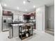 Modern kitchen with stainless steel appliances, granite countertops, and a center island at 4624 Willet Cooper Ct, Tampa, FL 33619