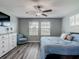 Serene main bedroom featuring a comfortable bed, large windows, and a neutral color palette at 4624 Willet Cooper Ct, Tampa, FL 33619