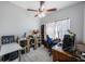 Comfortable workspace illuminated by natural light, featuring a ceiling fan and an inviting blue chair at 4815 Queen Palm Ne Ter, St Petersburg, FL 33703