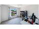 A bright bedroom with a large window with a view, fan, and desk with computer at 4815 Queen Palm Ne Ter, St Petersburg, FL 33703