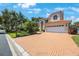 Beautiful suburban home with a red tile roof, manicured landscaping, and a spacious brick driveway at 4815 Queen Palm Ne Ter, St Petersburg, FL 33703