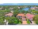 Exterior view of a beautiful home, lush landscaping, and a red brick driveway at 4815 Queen Palm Ne Ter, St Petersburg, FL 33703