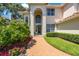 Inviting home featuring manicured landscaping and a brick path leading to the arched front entrance at 4815 Queen Palm Ne Ter, St Petersburg, FL 33703