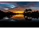 Scenic water view at dusk showcasing silhouetted palm trees and calm water reflecting the colorful sky at 4815 Queen Palm Ne Ter, St Petersburg, FL 33703