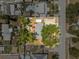 Aerial view of the property featuring the fenced backyard with mature trees, above ground pool, pergola, fire pit, and shed at 4920 17Th N Ave, St Petersburg, FL 33710