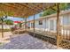 Inviting outdoor back patio area with pergola, brick pavers, and wooden deck, ideal for relaxing or entertaining at 4920 17Th N Ave, St Petersburg, FL 33710