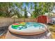 Backyard pool with floats, surrounded by grass and a wooden fence, and red shed at 4920 17Th N Ave, St Petersburg, FL 33710