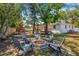 Spacious backyard featuring a fire pit with seating, mature trees, and a play area, perfect for outdoor enjoyment at 4920 17Th N Ave, St Petersburg, FL 33710