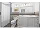Bathroom with a double sink vanity and tiled backsplash in a neutral tone at 4920 17Th N Ave, St Petersburg, FL 33710