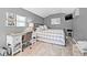 Bedroom featuring a desk, bed with gray plaid pattern, and wood look floors at 4920 17Th N Ave, St Petersburg, FL 33710