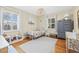 Bedroom features wood floors, a ceiling light fixture, multiple windows, and cute decor at 4920 17Th N Ave, St Petersburg, FL 33710