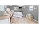 Bedroom features a desk, bed with gray plaid pattern, and wood look floors at 4920 17Th N Ave, St Petersburg, FL 33710