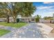 Charming single-story home with a well-maintained lawn, mature trees, and a paved driveway at 4920 17Th N Ave, St Petersburg, FL 33710