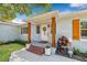 Inviting front porch with decorative pillars, a wreath, and well-maintained landscaping at 4920 17Th N Ave, St Petersburg, FL 33710
