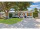 Beautifully landscaped front yard with vibrant green lawn, decorative shutters, and inviting front door at 4920 17Th N Ave, St Petersburg, FL 33710