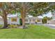 Charming single-story home features a well-manicured lawn, mature trees, and decorative shutters at 4920 17Th N Ave, St Petersburg, FL 33710