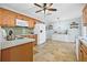 Bright kitchen features tile flooring, light blue walls, wooden cabinets, and stainless steel appliances at 4920 17Th N Ave, St Petersburg, FL 33710
