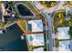 Aerial view of a modern home with a screened-in pool, a boat dock, and a waterfront property with marked boundaries at 5603 Tybee Island Dr, Apollo Beach, FL 33572