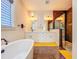 Elegant bathroom featuring double vanities, marble floors, modern lighting, and a luxurious freestanding soaking tub at 5603 Tybee Island Dr, Apollo Beach, FL 33572