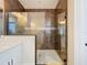 Sleek bathroom featuring a glass-enclosed shower with marble tiling, white vanity, and modern fixtures at 5603 Tybee Island Dr, Apollo Beach, FL 33572