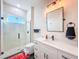 Bathroom featuring a glass shower, accent rug, vanity with sink, and decorative light fixture at 5603 Tybee Island Dr, Apollo Beach, FL 33572