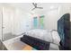 Bright bedroom features a platform bed, ceiling fan, and windows offering an abundance of natural light at 5603 Tybee Island Dr, Apollo Beach, FL 33572