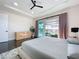Bright bedroom with modern ceiling fan and sliding glass doors leading to screened porch with a pool view at 5603 Tybee Island Dr, Apollo Beach, FL 33572