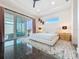 Bright bedroom with modern ceiling fan and sliding glass doors leading to screened porch with a pool view at 5603 Tybee Island Dr, Apollo Beach, FL 33572