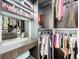 Spacious walk-in closet with custom shelving, hanging racks, vanity, and illuminated mirror for organized storage at 5603 Tybee Island Dr, Apollo Beach, FL 33572