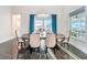 Formal dining room featuring elegant chandelier, table with seating, blue curtains and window view at 5603 Tybee Island Dr, Apollo Beach, FL 33572